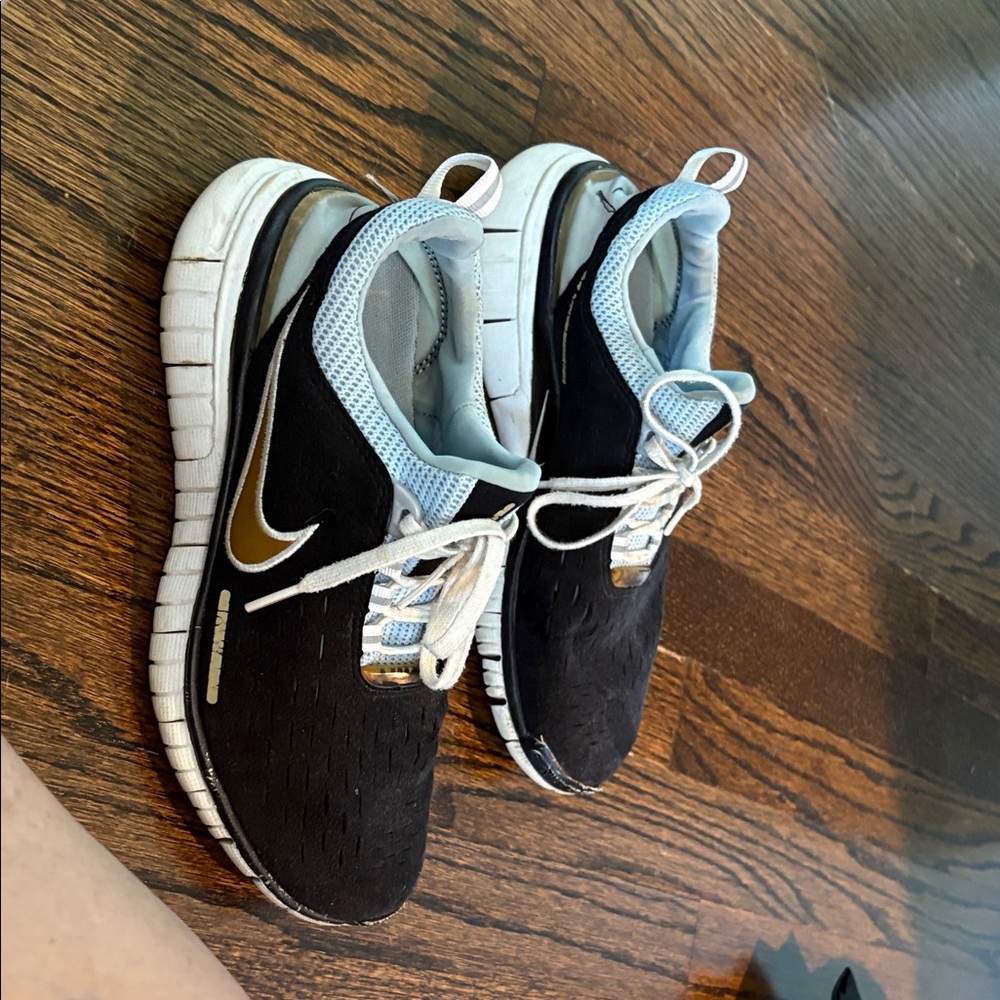 Nike Black Sneakers with Gold and White Accents